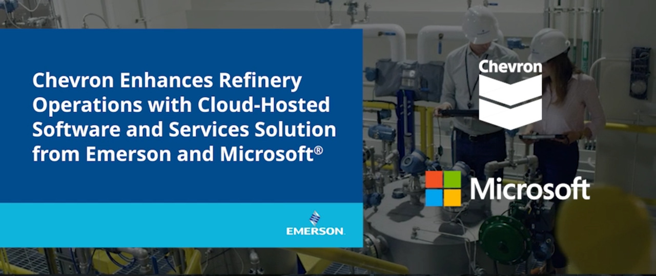 Serious caucasian unshaven worker in protective uniform and with hardhat using tablet for checking temperature in pipes. Factory interior.