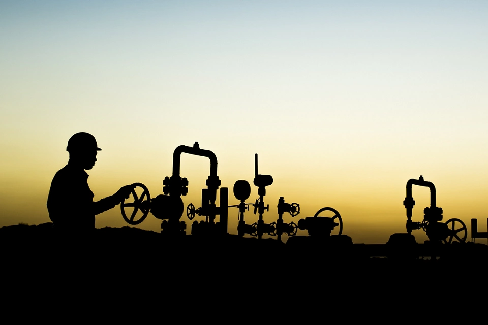 Sunset blue hour and silhouette of oilfield worker at oil well manifold  ; Shutterstock ID 531329203; purchase_order: Enterprise MARCOM; job: Emerson.com; client: Web; other: Requested by Susan Tencio
