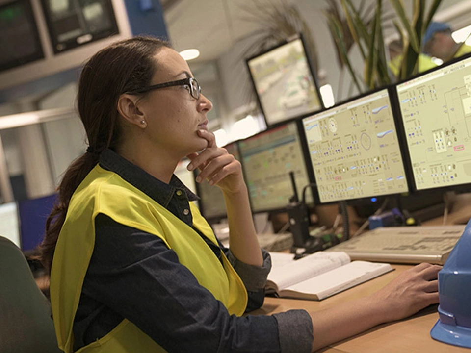 women engineer working in control room with HMI screens