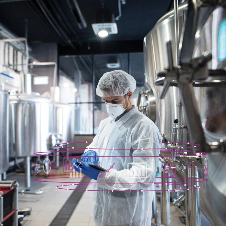 Life Sciences - Man in clean room PPE mask gloves booffant hat coverall lab coat biotech