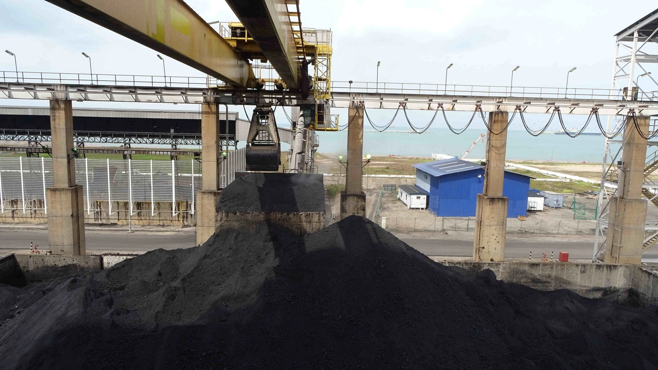 Products from delayed coker unit in petrochemical refinery plant. Lifting the products using bucket power by overhead crane. 