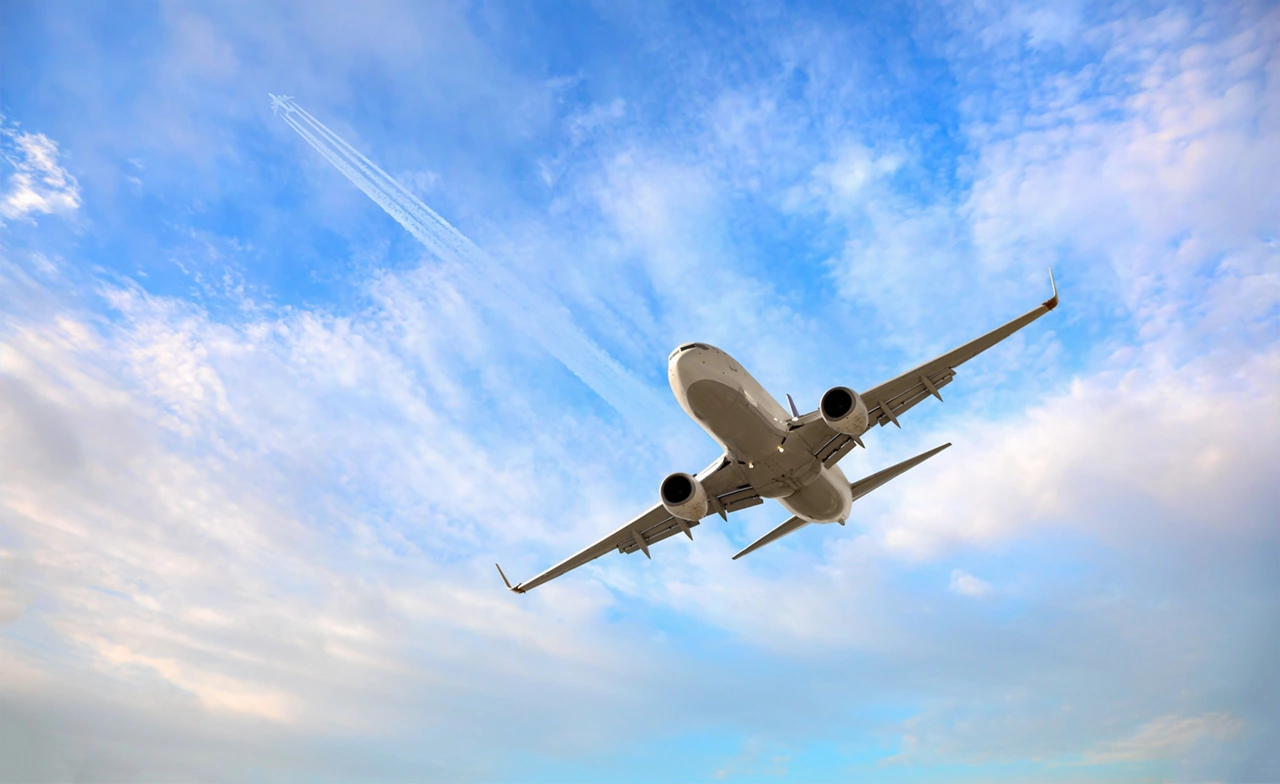 White passenger airplane flying in the sky amazing clouds in the background - Travel by air transport