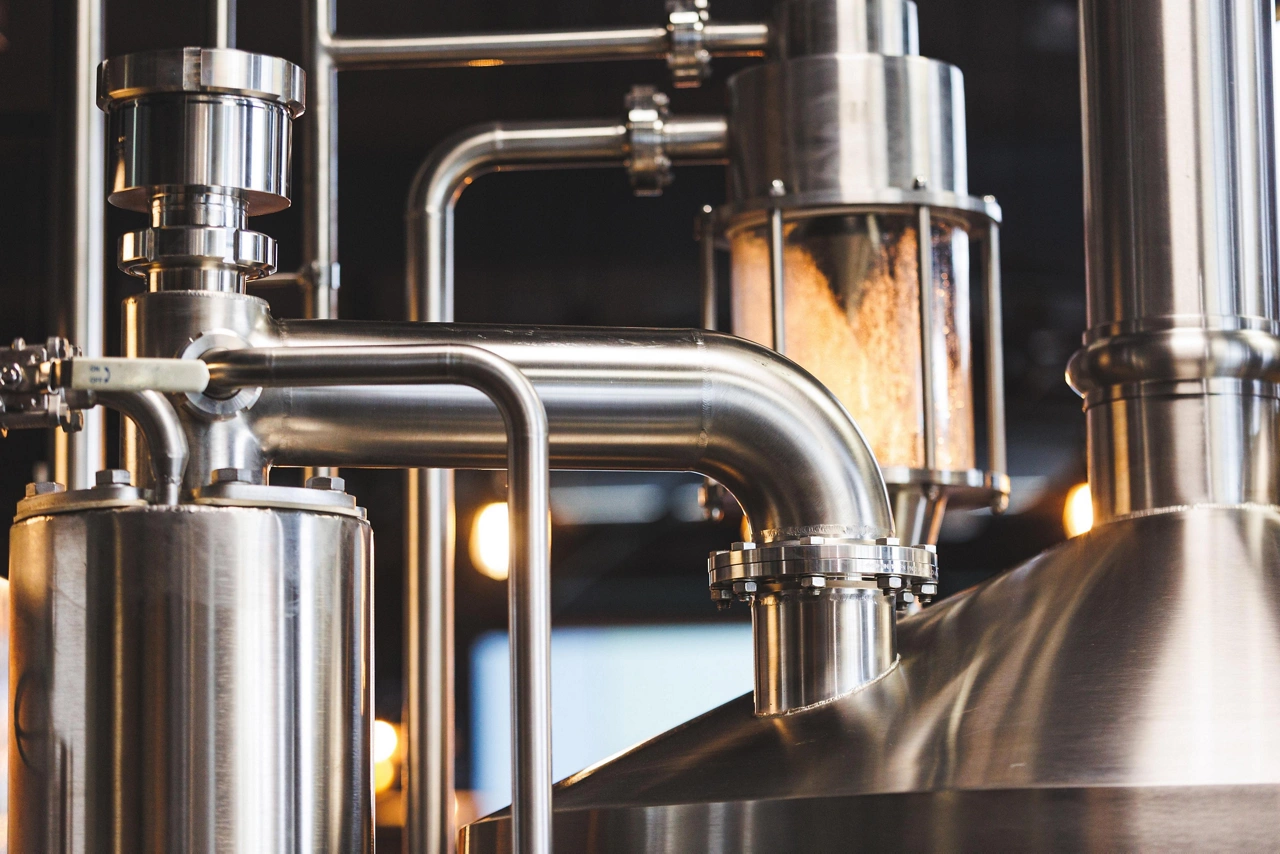 Beer brewing . Commercial brewing equipment close up shot. Industrial beer brewing stainless pipe