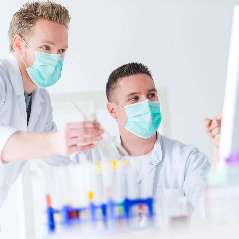men wearing masks holding beakers in lab Biotech Firm Automates Document Management Save Time Money Improve Compliance