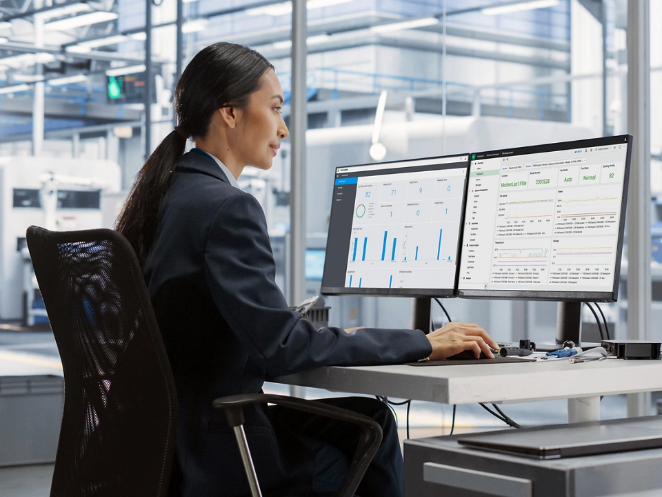 Engineer in a modern lab analyzing test data with NI SystemLink software dashboards, to monitor health of connected test systems, teams, and data.