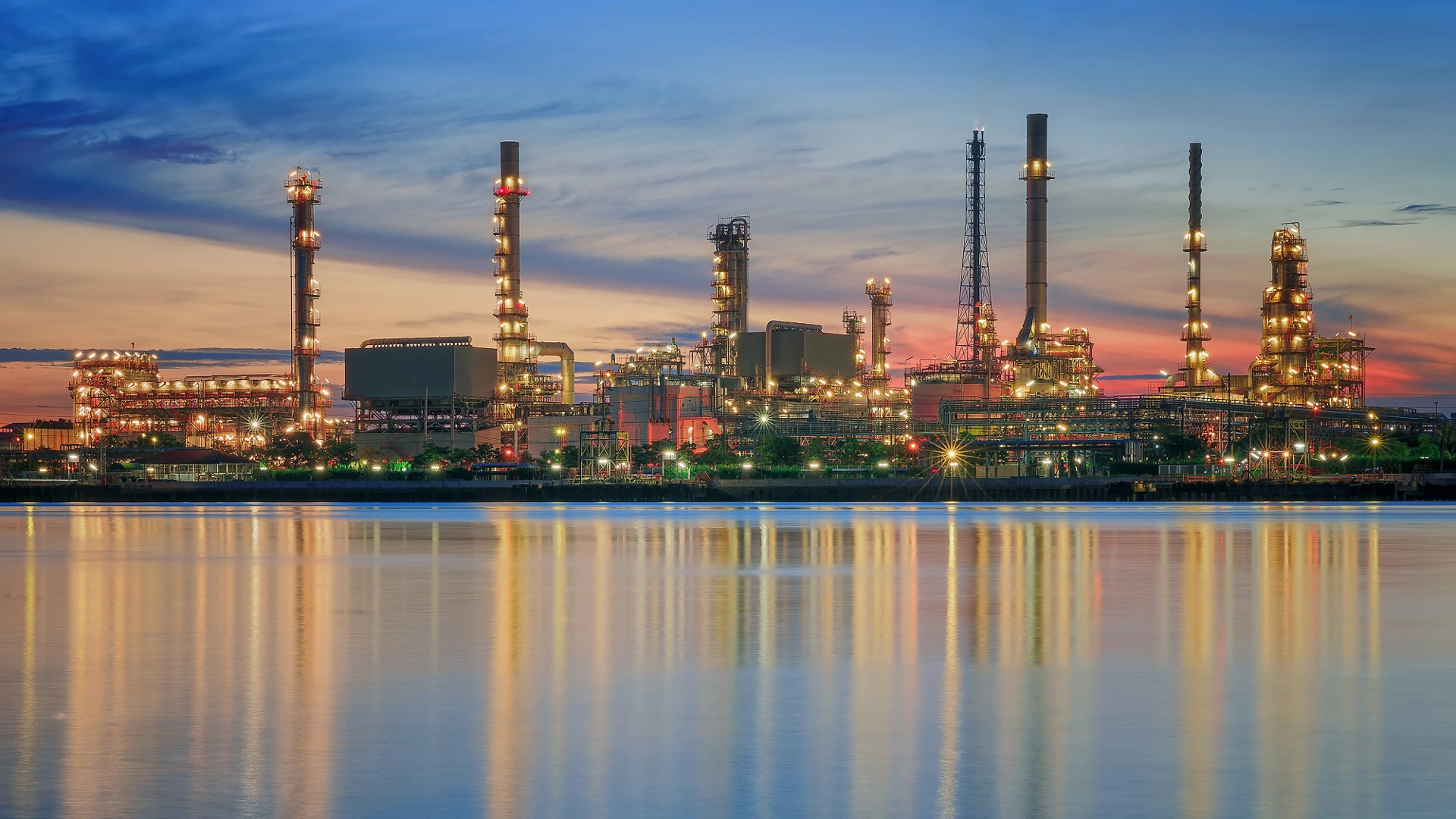 petrochemical plant in night time with reflection over the river