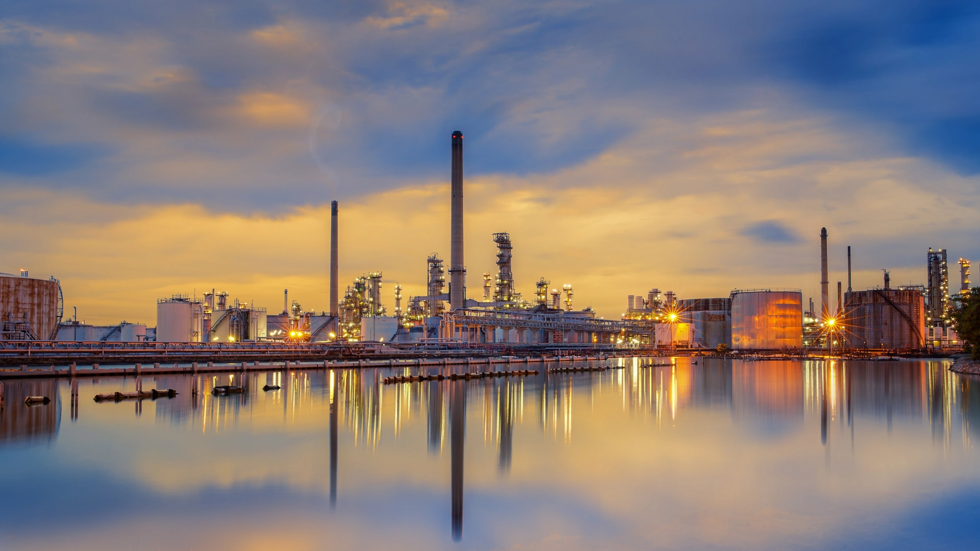 petrochemical plant in night time with reflection over the river